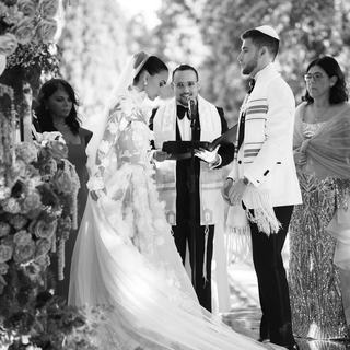 Black and white photo of Todd Bronshtein officiating a wedding ceremony in Spain