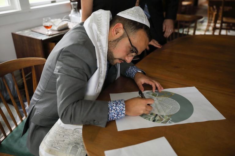Todd Bronshtein signing a ketubah, the Jewish marriage covenant